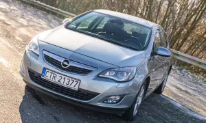 Srebrny Opel Astra J 1.6 benzyna na drodze.