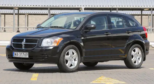 Czarny Dodge Caliber na parkingu. Wiele osób szuka dodge caliber opinie przed zakupem.